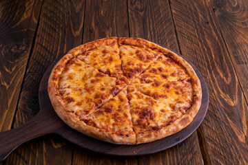Cheese Margarita pizza isolated on cutting board top view on dark background italian fast food