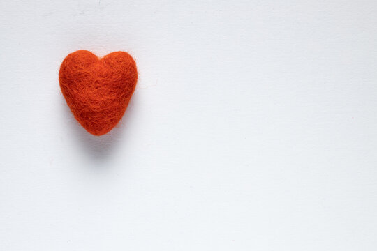 red felt heart on a white background
