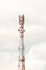 New GSM antennas on a high tower against a blue sky for transmitting a 5g signal are dangerous to health. Radiation pollution of the environment through cell towers. The threat of extinction