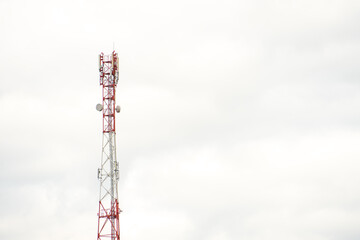 Obraz premium New GSM antennas on a high tower against a blue sky for transmitting a 5g signal are dangerous to health. Radiation pollution of the environment through cell towers. The threat of extinction