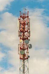 New GSM antennas on a high tower against a blue sky for transmitting a 5g signal are dangerous to health. Radiation pollution of the environment through cell towers. The threat of extinction