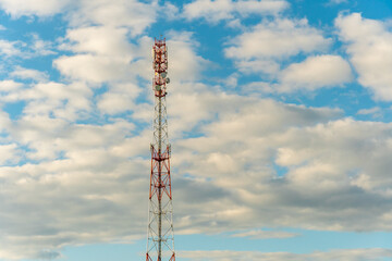 New GSM antennas on a high tower against a blue sky for transmitting a 5g signal are dangerous to health. Radiation pollution of the environment through cell towers. The threat of extinction