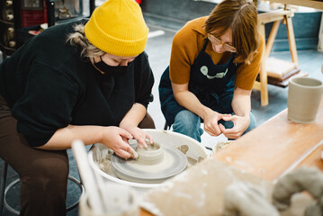 Fototapeta na wymiar Class on modeling of clay on a potter's wheel In a ceramic workshop