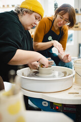 Class on modeling of clay on a potter's wheel In a ceramic workshop