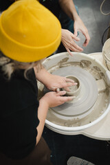 Fototapeta premium Class on modeling of clay on a potter's wheel In a ceramic workshop