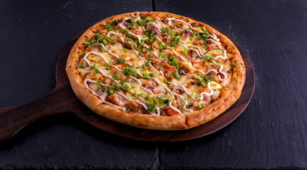 Hot and Sour Chicken pizza isolated on cutting board top view on dark background italian fast food