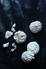 Meringues on a black background