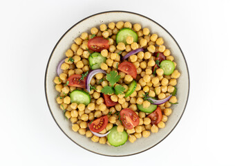Chickpea salad with tomatoes, cucumbers, onions and olive oil on a white background. Top view. Selective focus. Oriental and Mediterranean cuisine. 
