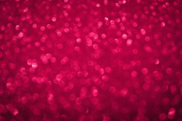 Viva Magenta bokeh lights background. Unfocused abstract red glitter holiday background. Christmas,...