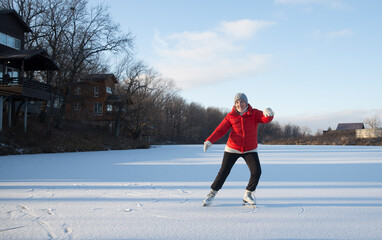 cheerful senior woman  ice skating on a frozen lake  in winter nature. Enjoying the little things....