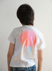 part of naked back of boy, child 10 years old in a white t-shirt bent over from back pain, concept...