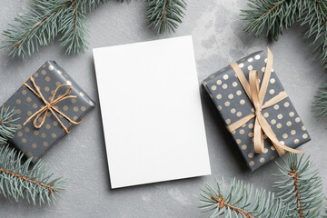 Fototapeta na wymiar Christmas mockup, blank greeting card with gift boxes and fir tree branches