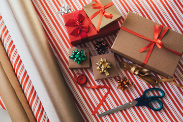 Fototapeta premium Items for wrapping Christmas presents: paper, scissors and colorful ribbons. Holiday preparations.