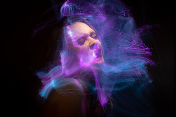 Abstract photography in the style of light painting. girl on a black background