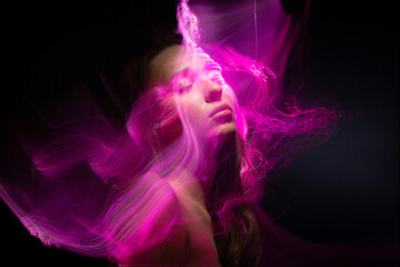 Abstract photography in the style of light painting. girl on a black background