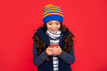 portrait of child blogging with phone. express positive emotion. greeting with winter holidays.