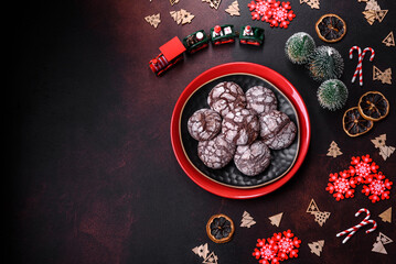 Delicious fresh brownies with Christmas decorations on a dark concrete background