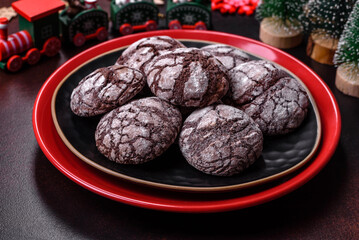 Delicious fresh brownies with Christmas decorations on a dark concrete background