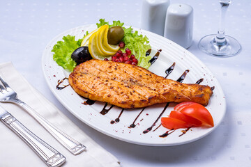 salmon fillet cooked on the grill on white plate