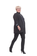 in full growth.confident business woman striding forward.