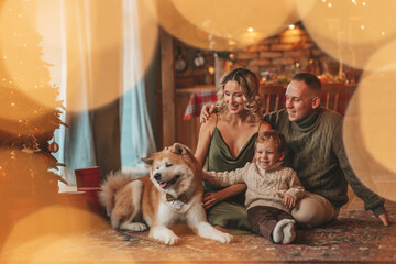 Candid authentic happy family during wintertime together enjoying holidays with dog at Xmas