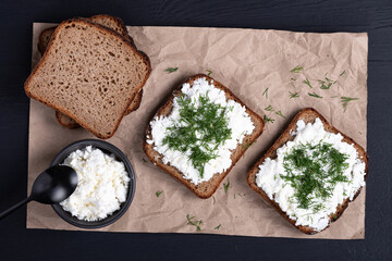Curd sandwiches with fresh herbs. Fresh rye bread with cottage cheese and green herbs. Concept...