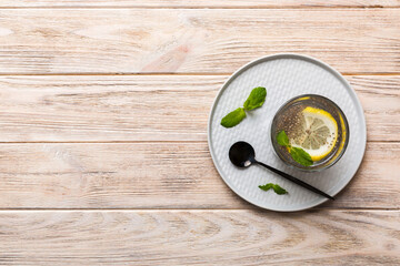 Healthy breakfast or morning with chia seeds lemon and mint on table background, vegetarian food, diet and health concept. Chia pudding with lemon and mint