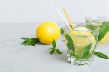 Mojito cocktail. Refreshing mojito cocktail with lime, lemon and mint in a tall glass with a stick
