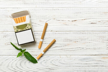 Pack of menthol cigarettes and fresh mint on colored table, Menthol cigarettes top view flat lay