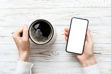 Top view of woman hands holding smart phone with blank copy space screen for your text message or...