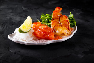 slice salmon fish and shrimp with salad on plate