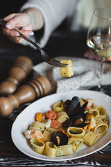Italian pasta with seafood on a dark wooden background. Food photography.