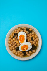 Boiled chickpea with spinach and boiled egg on plate