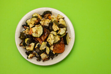 Mixed baked vegetables on light brown dish