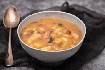 Sopa de pedra Portuguese Stone Soup with beans and sausages in the plate.