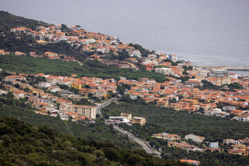 Fototapeta na wymiar View of Small touristic town by the sea. Cala Gonone, Sardinia, Italy.