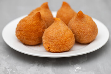 traditional brasilian fried drumsticks Coxinha de frango on dish