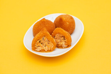 traditional brazilian fried drumsticks Coxinha de frango on a small dish