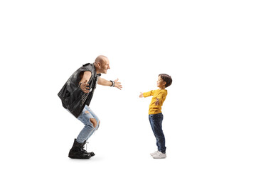 Full length profile shot of a boy meeting a man in a leather vest
