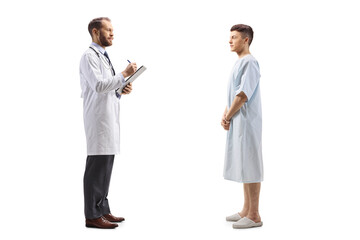 Full length profile shot of a male doctor and a young patient standing and talking