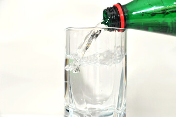 Pouring bottled mineral water into the glass