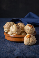 Bowl with chipa, typical Paraguayan cheese bread on blue tablecloth.