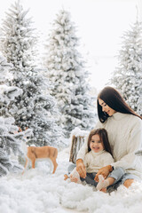 Fototapeta na wymiar Merry Christmas and Happy Holidays. Cheerful mom and her cute daughter girl
