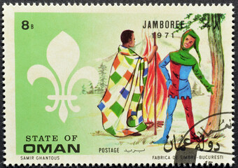 Cancelled postage stamp printed by Oman, that shows Scouts, circa 1971.