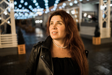 Cinematic night portrait of girl and lights in city with copy space - night life and youth concept