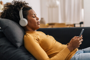Woman relaxing with some music at home