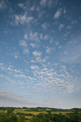 Fototapeta na wymiar Beautiful clouds above green fields
