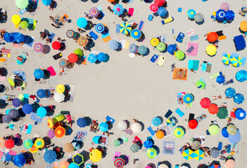 Aerial view of colorful umbrellas on sandy beach, people at sunset in summer in Sardinia, Italy....