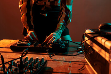Woman performer mixing techno music on turntables, playing record mix sounds on audio dj instrument...