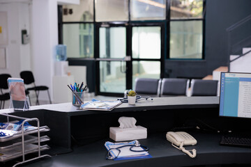Empty reception counter with nobody in it full with medical documents prepared for patient...